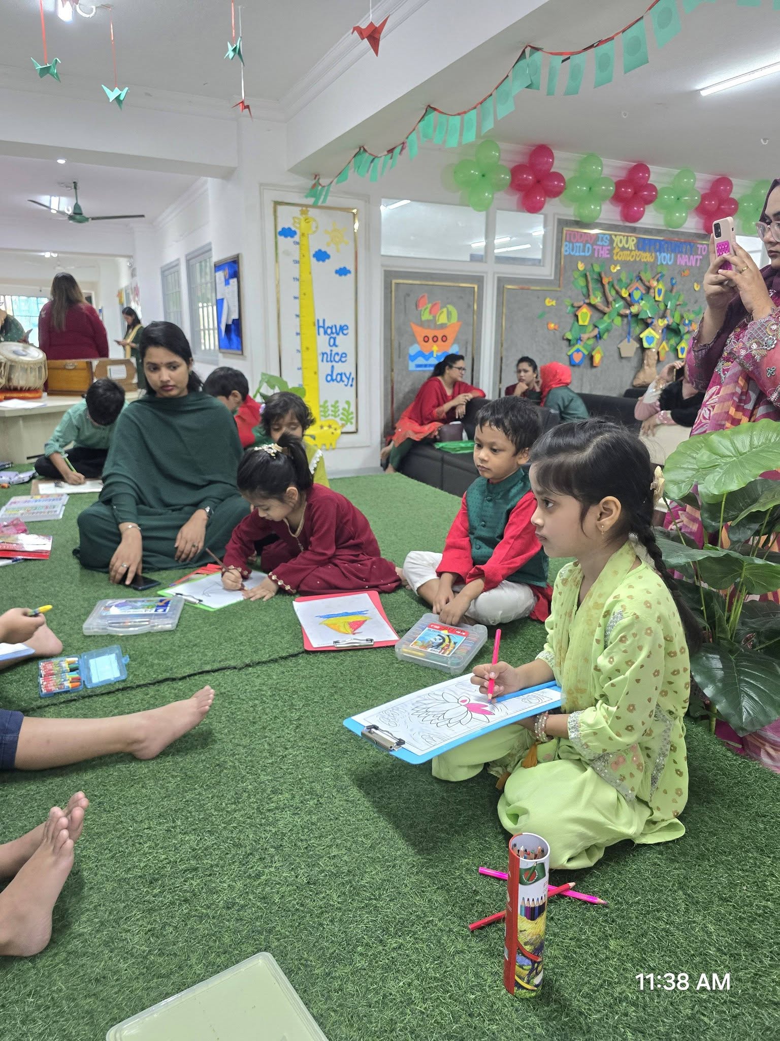 Students seated drawing and colouring during a cultural event
